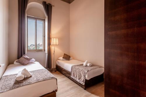 a room with two beds and a window at Notre Dame of Jerusalem Center in Jerusalem