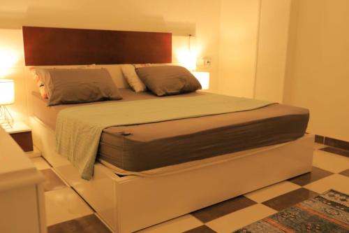 a bedroom with a large bed with a headboard at Casa De Amor in Quseir