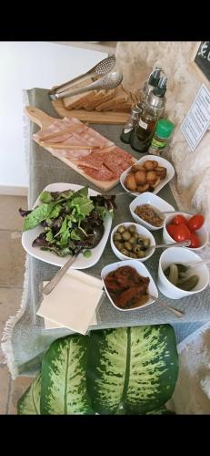 a table topped with plates of food and vegetables at Il Daviduccio ibla in Ragusa