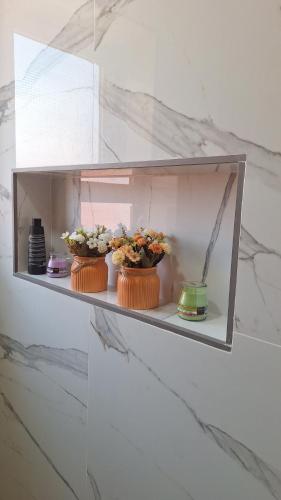 two cakes on a shelf with flowers in them at Suites au sein d'une Villa au centre ville de Rabat in Rabat