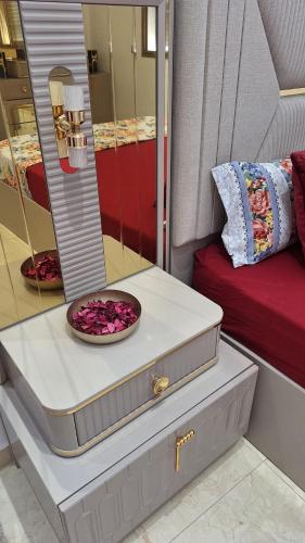a dresser with a bowl of flowers on it next to a bed at Suites au sein d'une Villa au centre ville de Rabat in Rabat