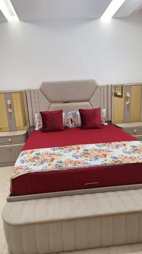 a bedroom with a large bed with red pillows at Suites au sein d'une Villa au centre ville de Rabat in Rabat
