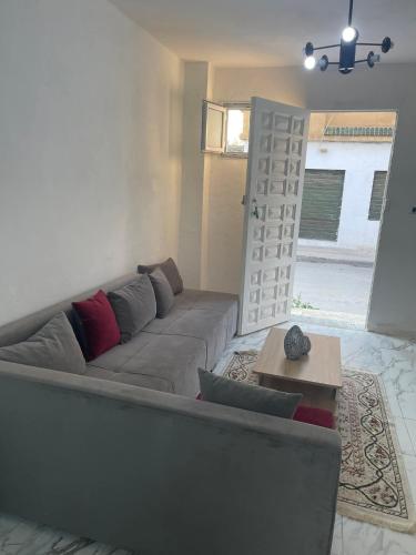 a living room with a couch and a table at House of la Marsa in Dar Tahar Zaouch