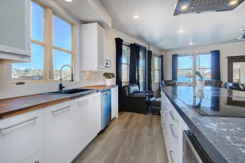 a kitchen with white cabinets and a counter top at She Shes Downtown Salidas Sunny Overlook in Salida