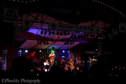 a group of musicians on a stage at night at She Shes Downtown Salidas Sunny Overlook in Salida