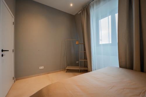 a bedroom with a large bed and a window at Superbe appartement 2 chambres en centre-ville in Liège