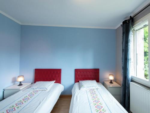 two beds in a room with blue walls at Relaxing Retreat in Bathernay in Bathernay
