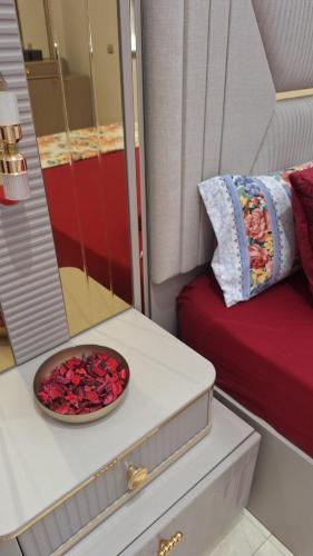 a table with a bowl of roses on it in a room at Suites au sein d'une Villa au centre ville de Rabat in Rabat