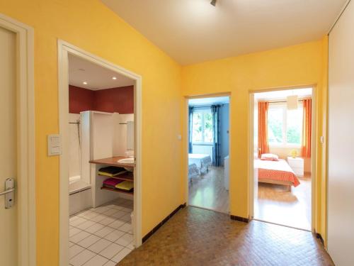 a room with yellow walls and a kitchen with a refrigerator at Relaxing Retreat in Bathernay in Bathernay