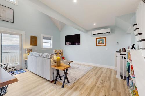 a living room with white walls and a table at The Glenora Guesthouse in Dundee
