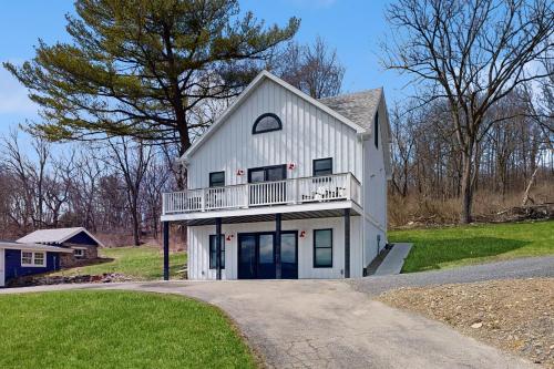 a white house with a balcony on a driveway at The Glenora Guesthouse in Dundee
