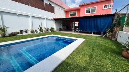 a swimming pool in the yard of a house at Casa Colibrí Ahuatepec Cuernavaca in Cuernavaca