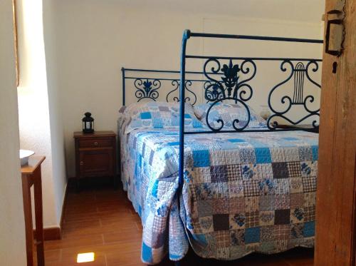 a bedroom with a bed with a quilt on it at Refugio da Maceira in Marvão