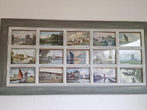 a picture frame of pictures on a wall at 197 Broadside Holiday Chalet near Broads & Beaches in Stalham
