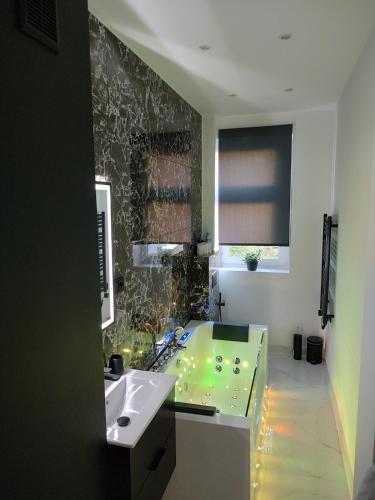 a bathroom with a sink and a mirror and a sink at Cozy Calming Apartment in Poznań
