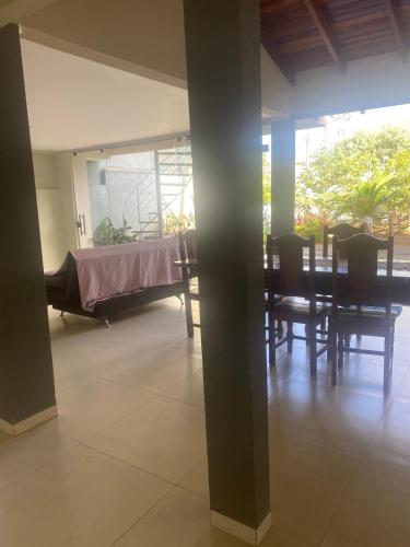 a room with a bed and a table and chairs at Pousadinha Safira in Sinop