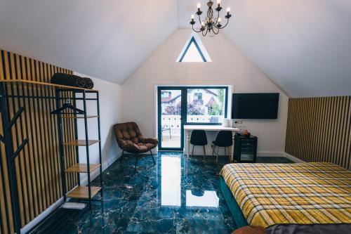 a bedroom with a bed and a table with chairs at Kalna iela 21 Rooms in Sigulda