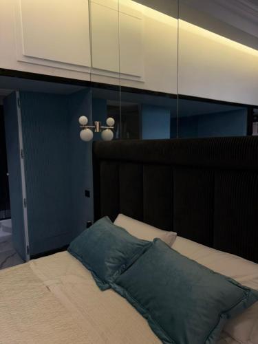 a bedroom with a bed with a mirror above it at AH Suite Trinità Dei Monti in Rome