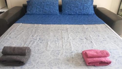 a bed with two towels on top of it at UrbanBreaks Viale Ungheria in Milan