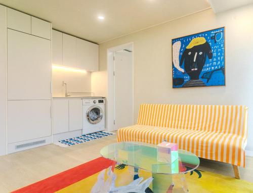 a living room with a couch and a glass table at newly built with elevator near Hongdae Mangwon in the super station area Onul in Seoul
