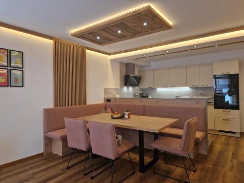 a kitchen and dining room with a wooden table and chairs at Apartment Lamtana in Ischgl