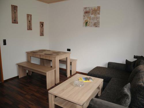 a living room with a couch and a coffee table at Ferienwohnung im Bayerischen Wald mit Balkon in Drachselsried