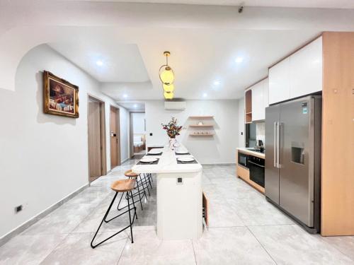 a kitchen with a white counter and a refrigerator at StayX Luxury Apartment near SECC in Ho Chi Minh City