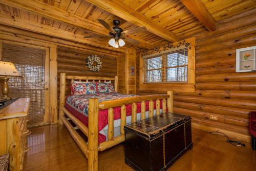 a bedroom with a bed in a log cabin at A Bears View in Glade