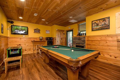 a game room with a pool table and a tv at A Getaway With A View by American Patriot Getaways in Shady Grove