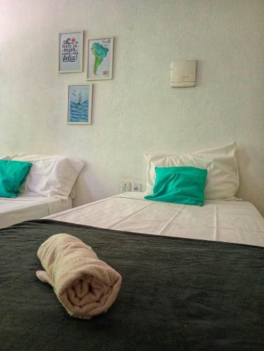 a hotel room with two beds with towels on them at MarJeri in Jericoacoara