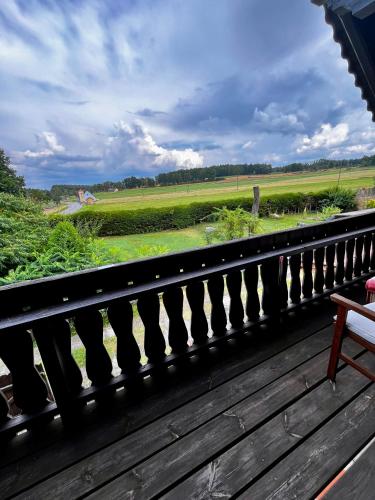 a balcony with a view of a green field at Familienapartments mit Balkon oder Terrasse und Garten in Ober-Lembach