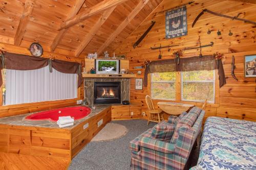a bedroom with a bed and a fireplace in a cabin at All Shook Up by American Patriot Getaways in Cove Creek Cascades