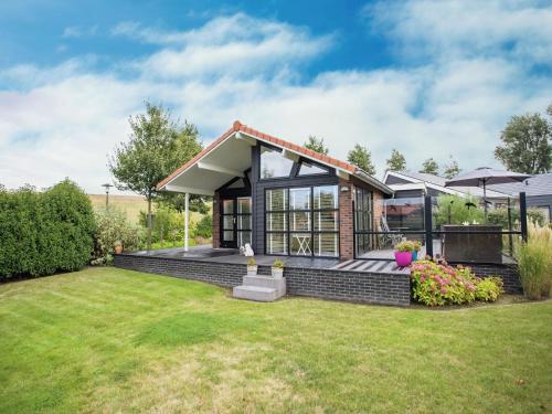 a house with a garden and a lawn at Chalet in Kattendijke near Eastern Scheldt in Kattendijke