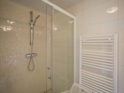 a shower with a glass door in a bathroom at Chalet in Kattendijke near Eastern Scheldt in Kattendijke