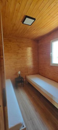 a room with a bed and a window and a table at Wataha Zawóz in Polańczyk