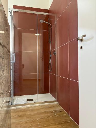 a shower with a glass door in a bathroom at Art Room In Pompei in Scafati