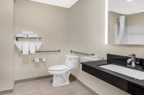 a bathroom with a toilet and a sink at Best Western Concord Inn and Suites in Concord