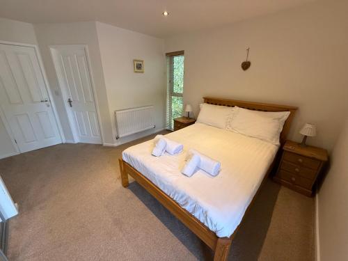 a bedroom with a bed with two towels on it at Luxury Riverside Retreat In Picturesque Setting in Clunton