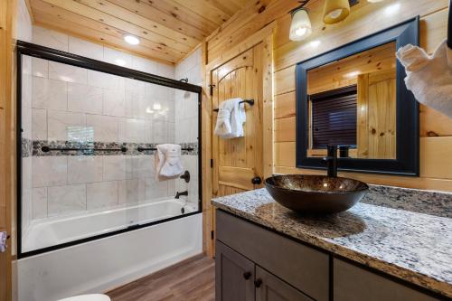 a bathroom with a sink and a shower with a tub at Amazing Views & a Pool by American Patriot Getaways in Cartertown