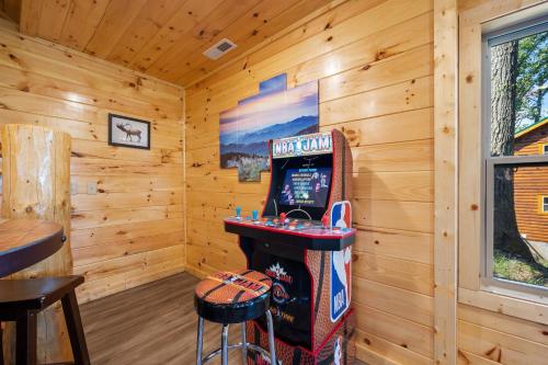 a room with a video game machine in a log cabin at Amazing Views & a Pool by American Patriot Getaways in Cartertown