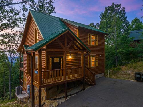 a log cabin with a porch and a green roof at Amazing Views & a Pool by American Patriot Getaways in Cartertown