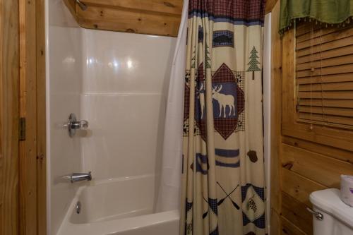 a bathroom with a tub and a shower curtain at Angels Majestic View in Williamsburg