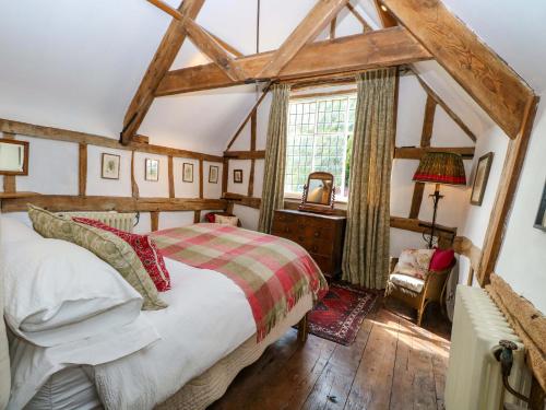 a bedroom with a bed and a desk and a window at Bank House in Norwich