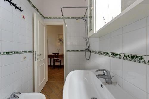 a white bathroom with a sink and a window at Apartment for 2 Florence Redi in Florence