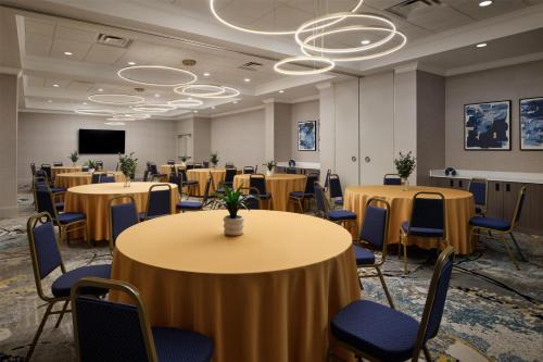 a conference room with tables and chairs and a screen at DoubleTree by Hilton Brunswick in Parkwood