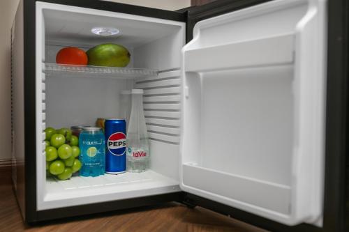 an open refrigerator with fruit and drinks in it at Léman Old Quarter in Hanoi