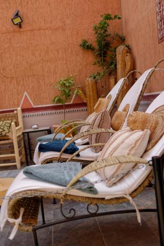 a row of wicker beds sitting in a room at Riad Parfums de OUARZAZATE in Ouarzazate