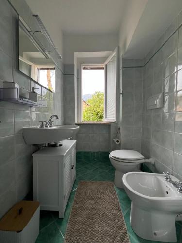 a bathroom with a sink and a toilet and a window at La Fontana di Norcia in Norcia