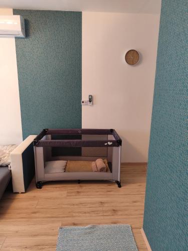 a small bedroom with a crib in a room at Égerliget Vendégház in Harkány