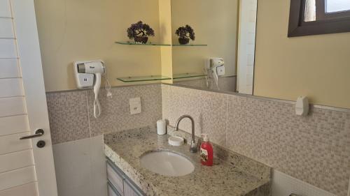 a bathroom with a sink and a mirror at Varandas do Mar pé na areia in Cumbuco